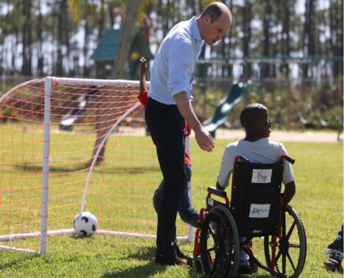 Prince William speaking with a young boy in a wheelchair